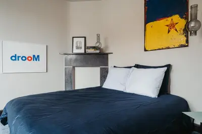 a bedroom with a bed with a blue blanket at Huis Hector Mechiels HOUSE in Lindeken