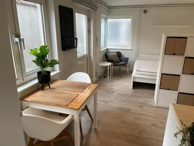a living room with a table and chairs and a couch at voskenslaan WS in Ghent