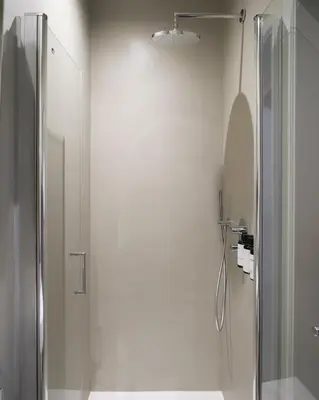 a shower in a bathroom with a glass shower stall at Lits de Lo - Boutique Rooms in Ghent