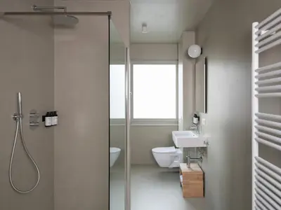 a bathroom with a shower and a toilet and a sink at Lits de Lo - Boutique Rooms in Ghent
