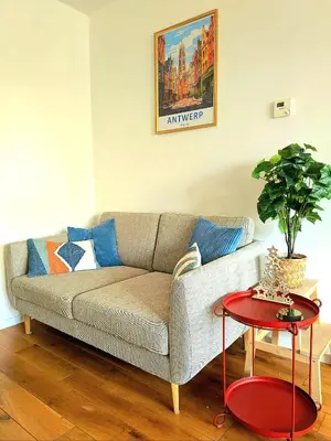 a living room with a couch and a table at Studio Viktory in Antwerp