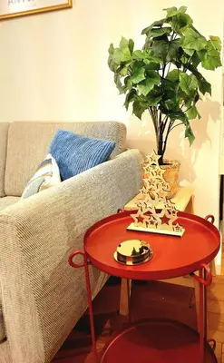 a red coffee table in front of a couch at Studio Viktory in Antwerp