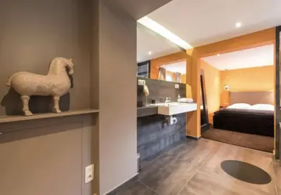 a hotel room with a statue of a horse on a shelf at Villa Sablon in Brussels