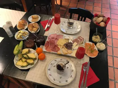 a table with plates of food on top at B&B Sablon Antwerp in Antwerp