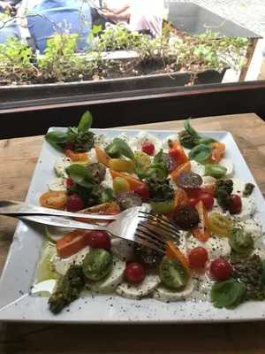 a plate of vegetables with a fork and knife at B&B Sablon Antwerp in Antwerp