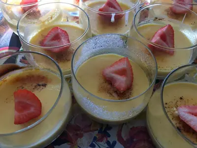 a bunch of cups of food with a strawberry in them at B&B Sablon Antwerp in Antwerp