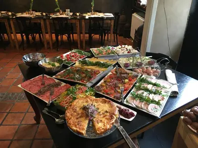a table with many different types of food on it at B&B Sablon Antwerp in Antwerp