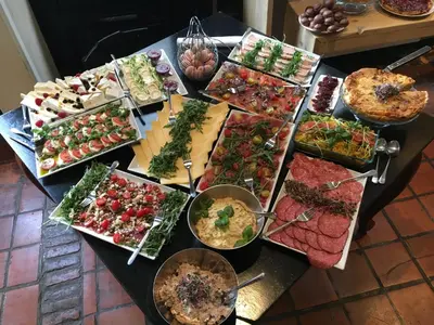 a table topped with lots of appetizers and food at B&B Sablon Antwerp in Antwerp