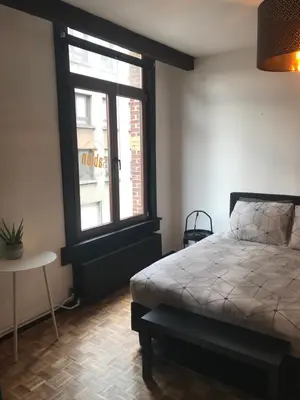 a bedroom with a bed and a window at B&B Sablon Antwerp in Antwerp