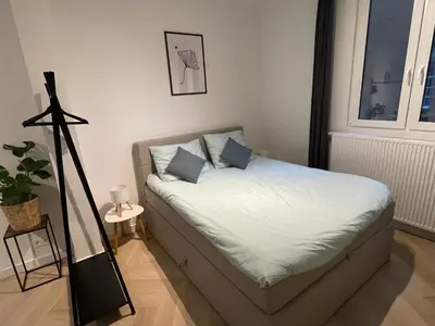 a bed with two pillows on it in a room at Stadsstudio op toplocatie in Antwerp