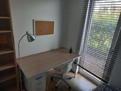 a desk in a room with a lamp and a window at Monastery Garden - 2 single and little rooms - bed & free breakfast - shared accomodation where landlord lives in Wezembeek-Oppem