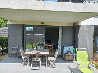 a patio with a table and chairs on a patio at Monastery Garden - 2 single and little rooms - bed & free breakfast - shared accomodation where landlord lives in Wezembeek-Oppem