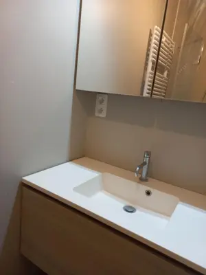 a bathroom counter with a sink and a mirror at Monastery Garden - 2 single and little rooms - bed & free breakfast - shared accomodation where landlord lives in Wezembeek-Oppem