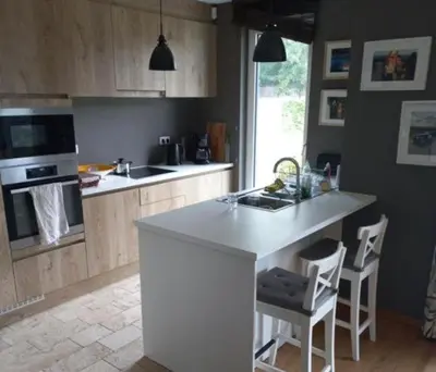 a kitchen with a white island in a kitchen at Monastery Garden - 2 single and little rooms - bed & free breakfast - shared accomodation where landlord lives in Wezembeek-Oppem