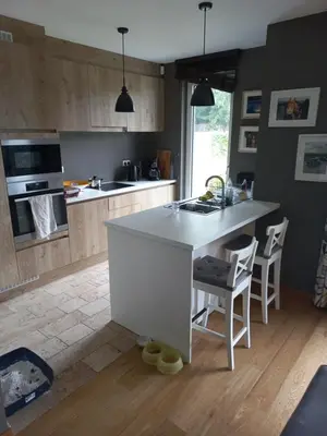 a kitchen with a white island in a room at Monastery Garden - 2 single and little rooms - bed & free breakfast - shared accomodation where landlord lives in Wezembeek-Oppem
