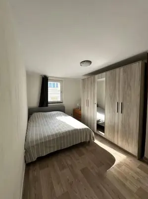 a bedroom with a bed and a large mirror at chill corner in Brussels