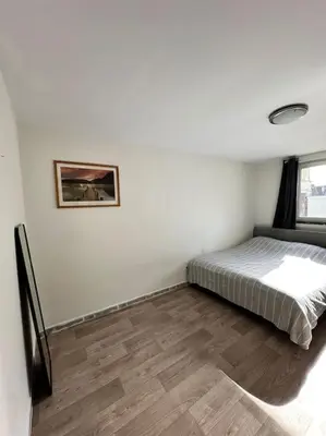a bedroom with a bed and a picture on the wall at chill corner in Brussels