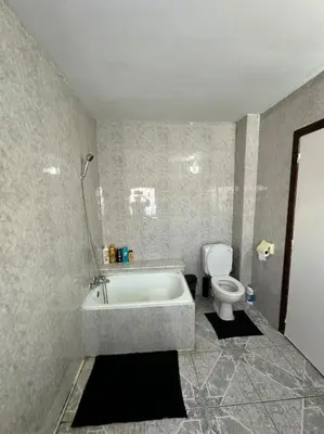 a bathroom with a bath tub and a toilet at chill corner in Brussels