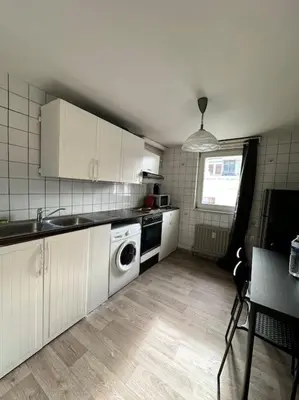 a kitchen with a washer and a sink and a dishwasher at chill corner in Brussels