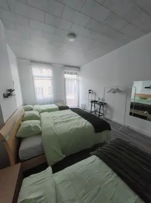 a bedroom with four beds in a room with at The Castle in Niel