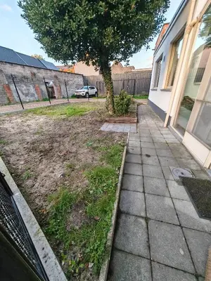 a sidewalk in front of a house with a tree at The Castle in Niel