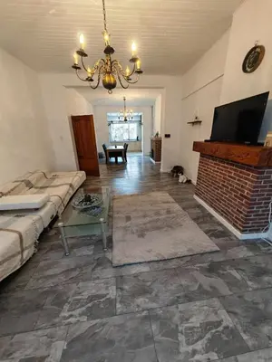 a living room with a couch and a fireplace at The Castle in Niel