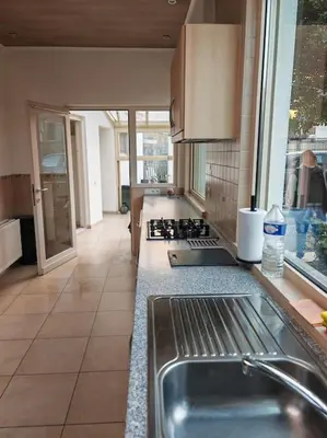 a kitchen with a sink and a counter top at The Castle in Niel