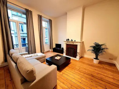 a living room with a couch and a fireplace at Le Duplex-suite Joséphine in Brussels