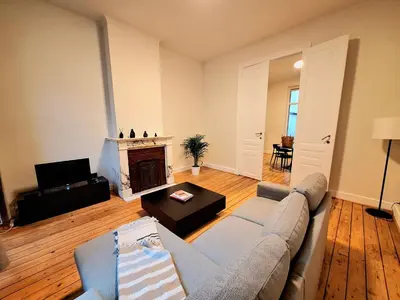 a living room with a couch and a fireplace at Le Duplex-suite Joséphine in Brussels