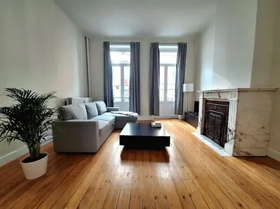 a living room with a couch and a fireplace at Le Duplex-suite Joséphine in Brussels