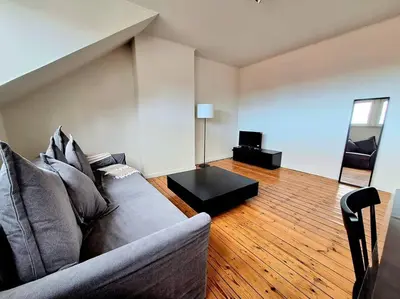 a living room with a couch and a table at La Suite Julienne in Brussels