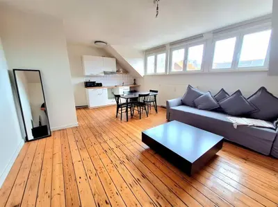 a living room with a couch and a table at La Suite Julienne in Brussels