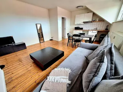 a living room with a couch and a table at La Suite Julienne in Brussels