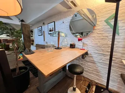 a room with a wooden table and a mirror at Le loft des artistes in Brussels