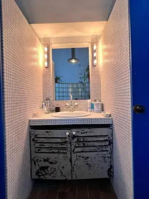 an old bathroom with a sink and a mirror at Le loft des artistes in Brussels