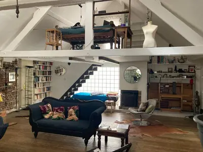 a living room with a couch and a loft at Le loft des artistes in Brussels