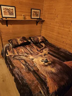 a bed with a painting of a goat on it at Casa De Los Ciervos in Stekene