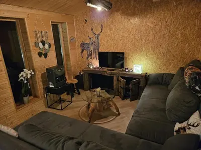 a living room with a couch and a table at Casa De Los Ciervos in Stekene