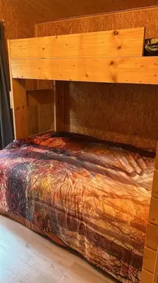a wooden bunk bed in a room at Casa De Los Ciervos in Stekene