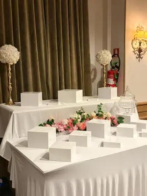 a table with white tables with flowers on it at Château à 10 minutes de Bruxelles in Beersel