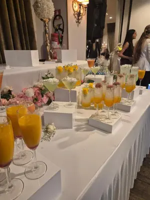 a long white table with glasses of orange juice at Château à 10 minutes de Bruxelles in Beersel
