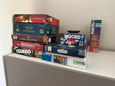 a stack of books sitting on a shelf at Sakura Lodging in Bossut-Gottechain
