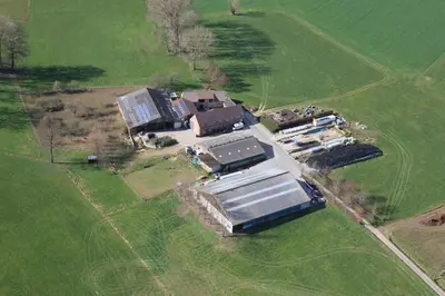 an aerial view of a house in a field at De Bronne in Herzele