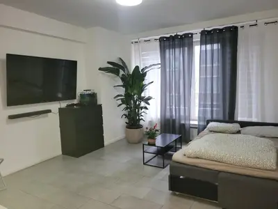 a living room with a couch and a flat screen tv at Pleasant Studio ready for you to enjoy in Antwerp