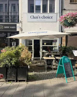 a table with an umbrella in front of a restaurant at Pleasant Studio ready for you to enjoy in Antwerp