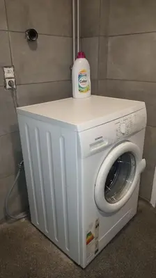 a washing machine with a bottle on top of it at Pleasant Studio ready for you to enjoy in Antwerp