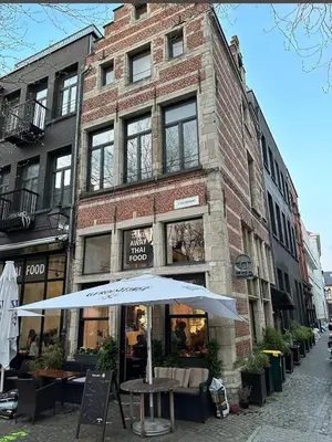 an umbrella in front of a brick building at Pleasant Studio ready for you to enjoy in Antwerp