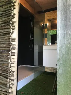 a bathroom with a shower with a glass door at Peace in Assenede