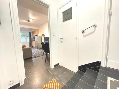 a hallway with a door leading to a living room at Duden Park Brussels - Cosy APT 1 Bedroom in Brussels