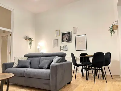a living room with a couch and a table at Charming Uccle - 1 Bedroom APT Brussels in Brussels